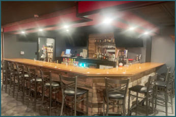 Picture of the bar in Trailhead Bar and Grill with the bartender.